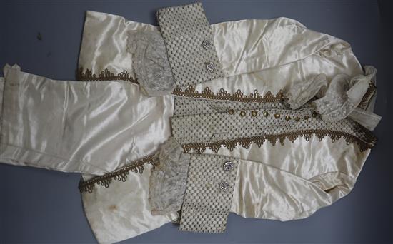 A 19th century cream and gold page boys suit with diamonte buttons, gold thread edging and lace cuffs